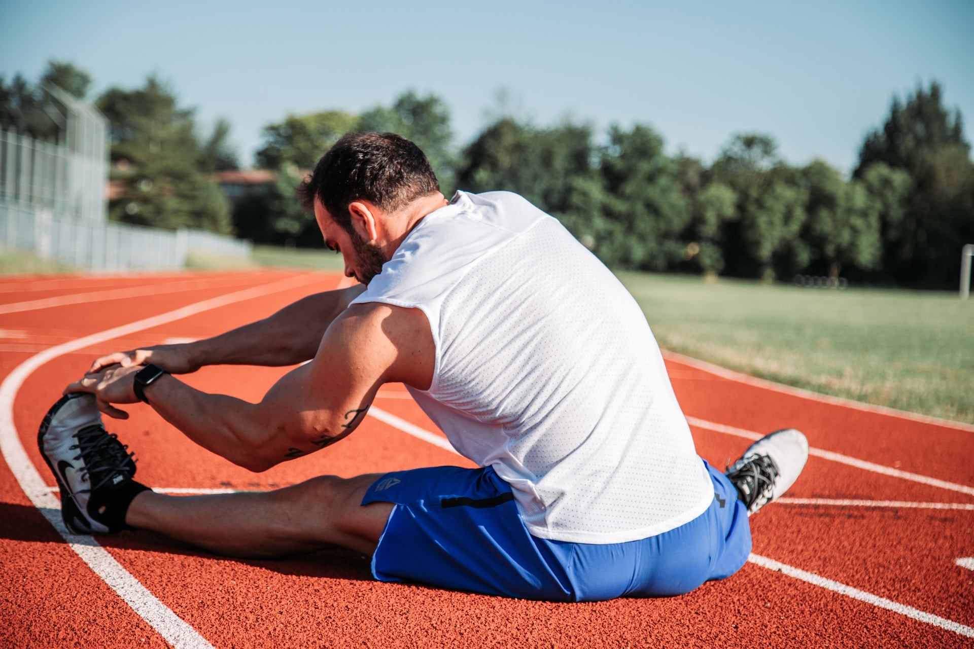 runner stretching on the ground